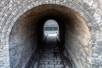 Fototapeta na wymiar Arched entry in the ancient walls protecting the Old city of Pingyao, Shanxi province, China. Pingyao is a UNESCO World Heritage Site