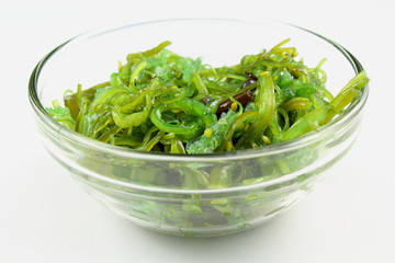 wakame salad with sesame in a small glass bowl isolated