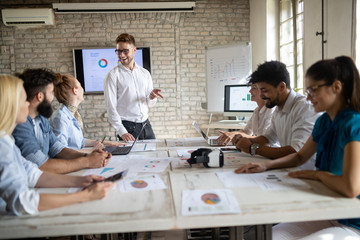 Successful happy group of people learning software engineering and business during presentation