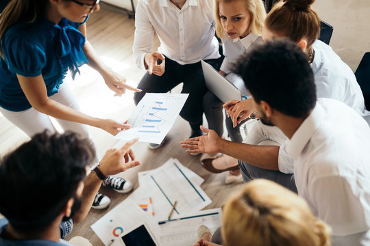 Business, technology and people concept - creative team or designers working in office