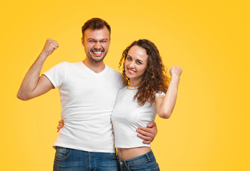 Fototapeta premium Cheerful couple hugging and gesturing