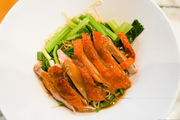 Close up of roasted duck noodles in the white plate