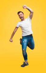 Excited casual man flying up in jump