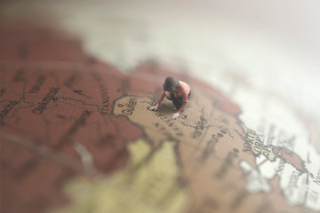 surreal image of a woman looking for a destination in a giant globe