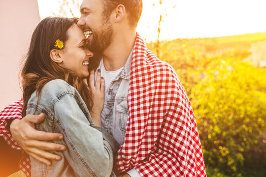 Couple laughing and hugging near field