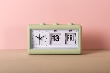 Vintage clock with calendar showing Friday 13th
