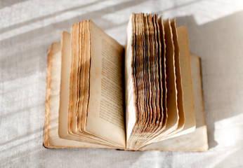 Open old book with faded pages