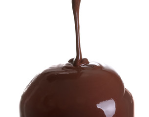 Pouring of melted chocolate on white background