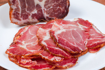 Sliced dried pork neck against of rest of the piece