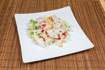 Salad of сrab sticks and napa cabbage on dish