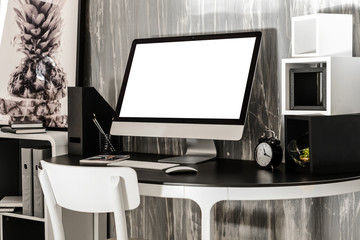 Stylish workplace with modern computer near grey wall