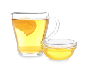 Cup of hot tea with lemon and honey on white background