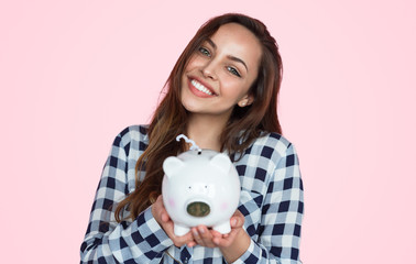 Charming girl with piggy bank