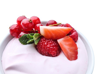 Bowl with tasty yogurt and berries on white background, closeup