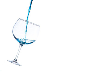 liquid splashing into a cocktail glass on a white background