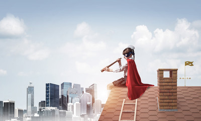 Girl power concept with cute kid guardian against cityscape back