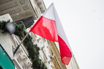 Polish flag on the building against the sky