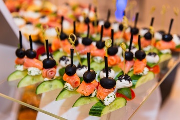 A plate with different snacks and canape at a party
