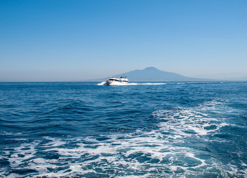  Cruise Boat in front of Mount Vesuvius in Bay of Naples at Sorrento resort town. Italy