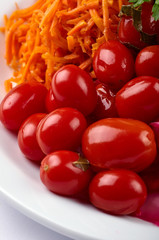 Small pickled tomatoes. Healthy and tasty grated carrots. Simple vegetable appetizer for breakfast, lunch, dinner. Traditional Russian, Ukrainian, Slavic, Belarusian snack.