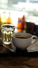 Well mixed black hot black coffee in white coffee cup on wood table served in a restaurant in a coffee break time, popular drink for meeting place and party time, value added design for better sales