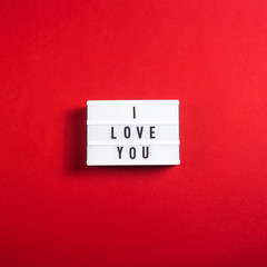 I love you written on a decorative lamp on a bright red background. Valentine's day concept
