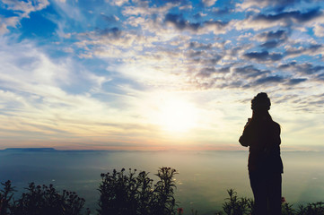silhouette women traveller standing to see the highland mountains. © stockphotokae