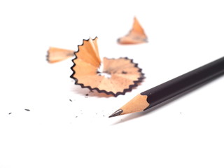 Pencil with sharpening shavings on white background