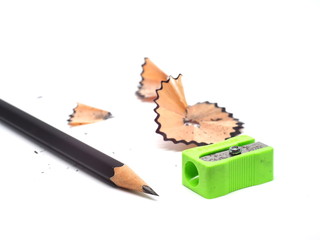 Pencil with sharpening shavings on white background