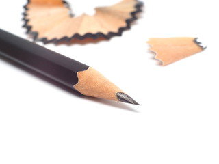 Pencil with sharpening shavings on white background