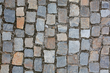 Wet cobbled stone sidewalk after the rain in historical center in Prague