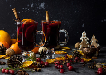 milled Hot wine with Christmas decorations background. Holiday dark photo.