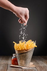 Hand adding a pinch of salt