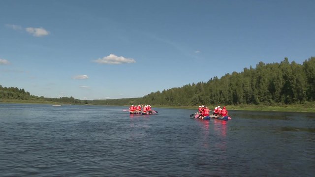 Rafting on catamarans on the river .Tourists rowing on catamarans. Outdoor activity.