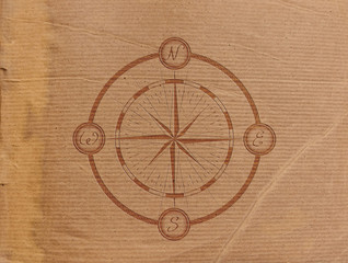 Fototapeta na wymiar sign embossed nautical marine compass on the background of old parchment paper