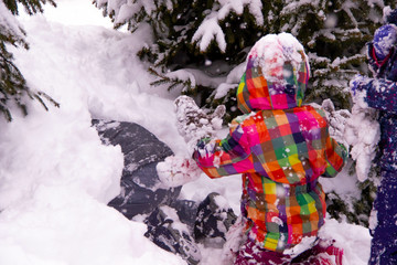 Children play in the snow after heavy snow, mountains of snow