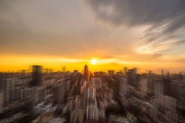 Abstract blur sunlight of sunset background of cityscape and building at evening. moving camera zoom shot.