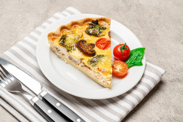 Slice of traditonal homemade spinach chicken quiche tart or pie on plate