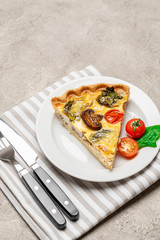 Slice of traditonal homemade spinach chicken quiche tart or pie on plate