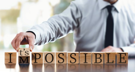 Impossible Concept With Businessman and  Wooden Blocks