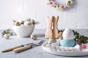 Homemade easter cookies in the shape of  a  funny  bunny, quail eggs  and chicken egg. Easter  celebration table setting. Holiday decorations.