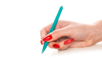 Beautiful female hand with red nails write with pen