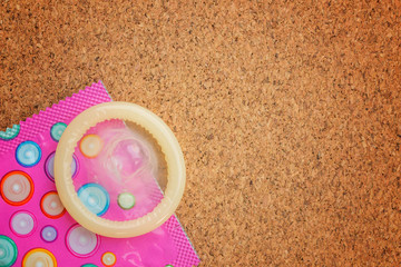 one condom on cork board background can input text