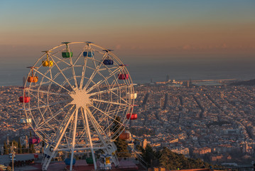 Ferris wheel on Tibidabo hill Barcelona at sunset