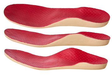 Orthotics on a white background. Insert in shoes to support the foot. Red leather medical insole 