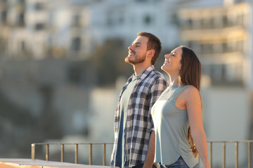 Happy couple breathing fresh air in a town