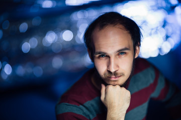 portrait of a guy in a hat on a blurred background