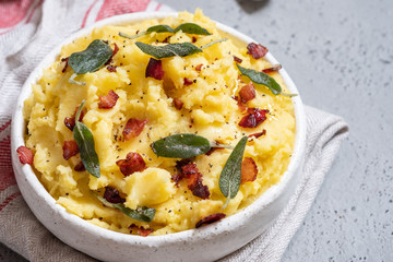 Mashed potatoes with crispy bacon and sage in a bowl