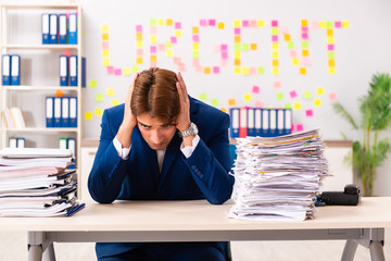 Young employee suffering from excessive work  