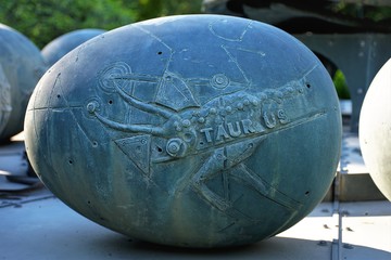 A concrete sculptured in egg shaped with a low relief ox mark on the surface, creating the TAURUS...